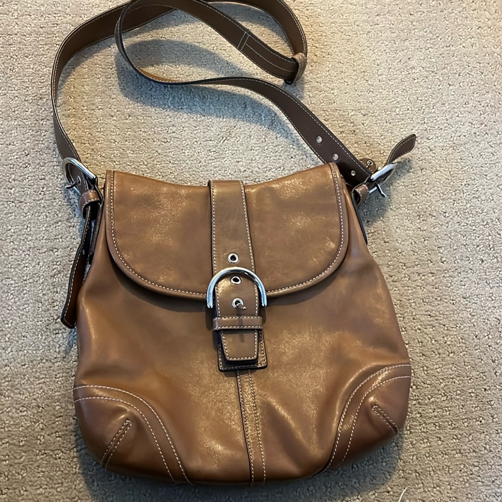 Coach crossbody bag. Saddle leather with silver clasp and buckles.